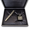 Aurora pen and ink set in an open black box with the Aurora logo.