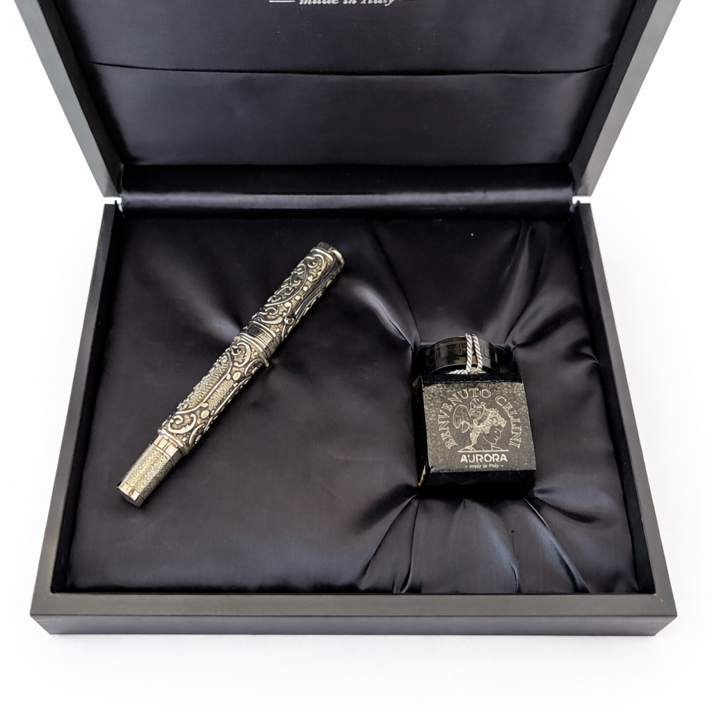 Aurora pen and ink set in an open black box with the Aurora logo.