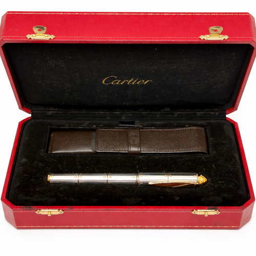 Cartier pen in a red and gold case on a white background