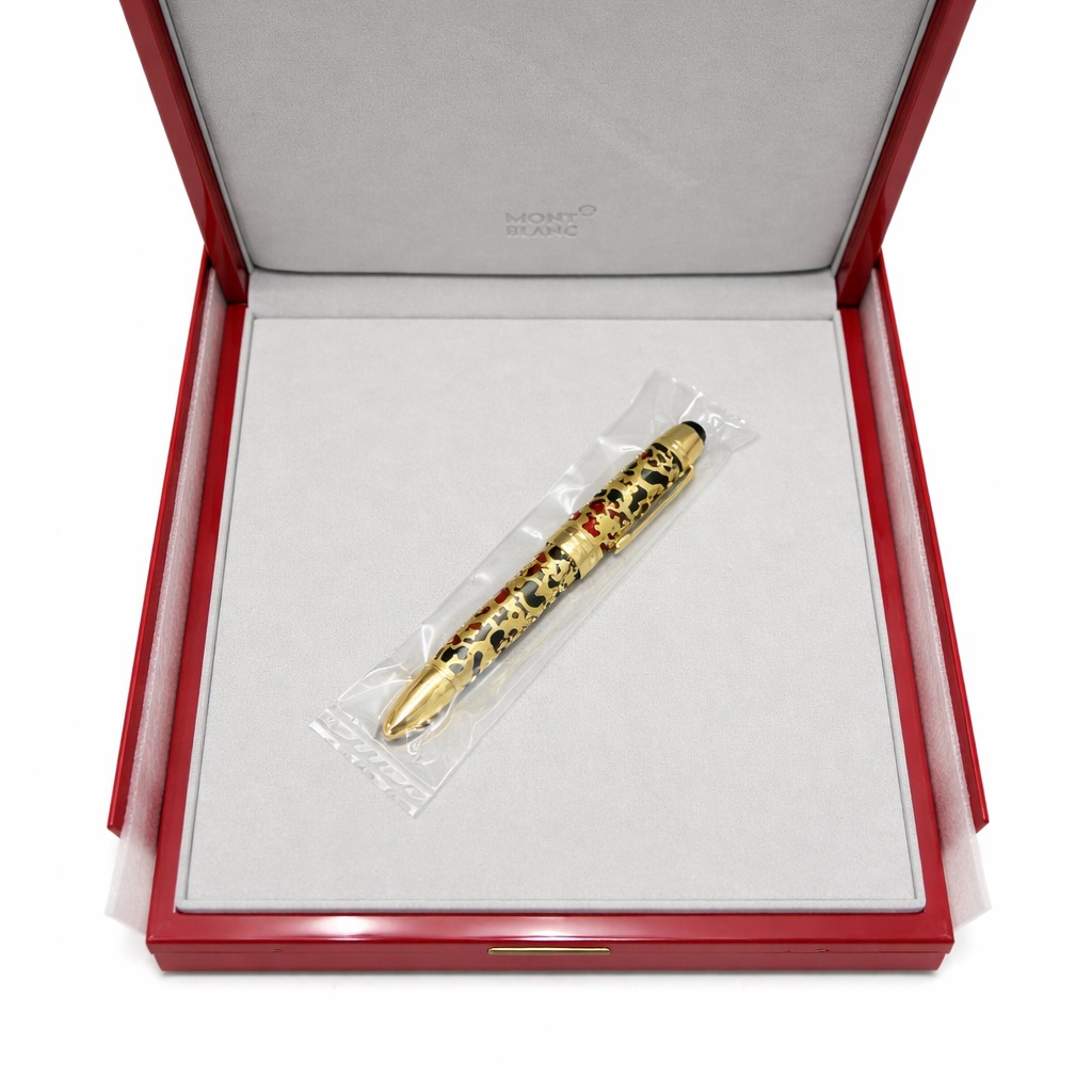 Gold pen with gemstones in a red box 
