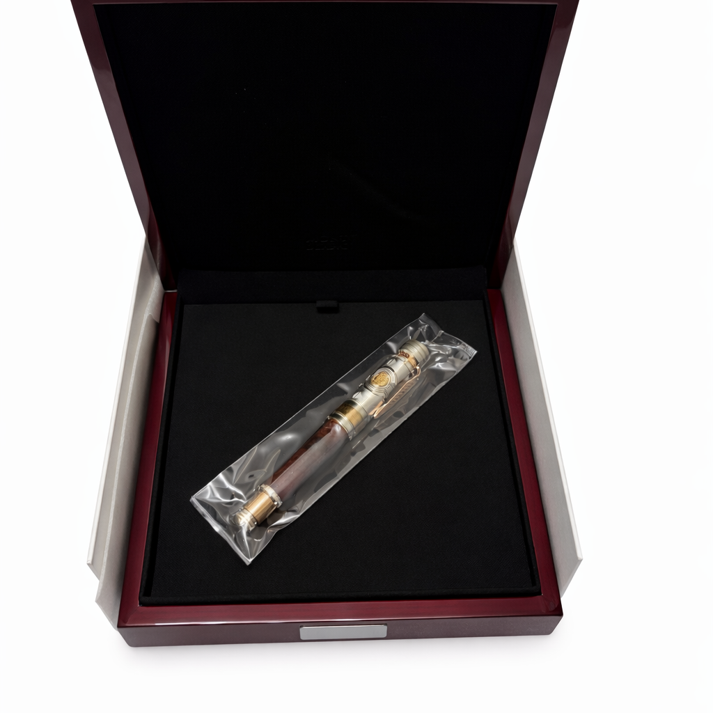 Fountain pen in a clear plastic bag inside an open wooden box 