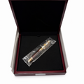 Fountain pen in a clear plastic bag inside an open wooden box 